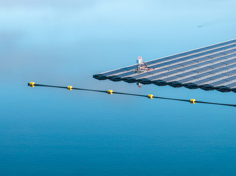 Aerial view of the floating solar system at Cottbuser Ostsee with solar panels on the water surface and a yellow buoyed barrier line in Cottbus Brandenburg Germany. Aerial view of the floating solar system at Cottbuser Ostsee with solar panels on the water surface and a yellow buoyed barrier line in Cottbus Brandenburg Germany.