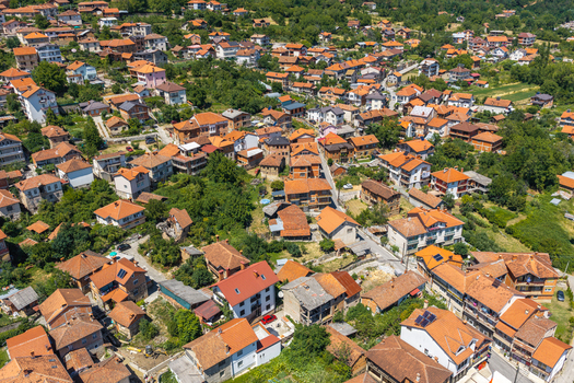 Aerial view of the historic village of Vevchani with its traditional houses red tiled roofs and lush green surroundings in Vevchani Vevcani Municipality North Macedonia. Aerial view of the historic village of Vevchani with its traditional houses red tiled roofs and lush green surroundings in Vevchani Vevcani Municipality North Macedonia.