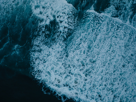 Aerial view of crashing ocean waves with white foam and deep blue water at La Jolla Cove San Diego California United States. Aerial view of crashing ocean waves with white foam and deep blue water at La Jolla Cove San Diego California United States.