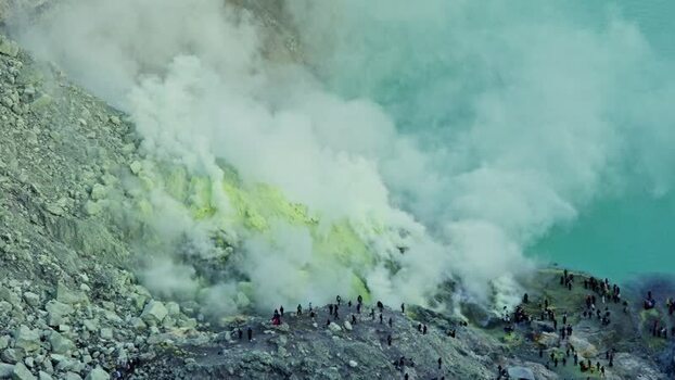 View of Kawah Ijen crater lake and sulfur fumes Indonesia.