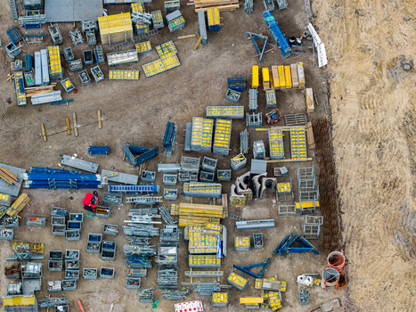 Aerial view of the construction site at Heizkraftwerk Reuter West with organized storage of industrial materials metal containers and equipment in Berlin Berlin Germany.
