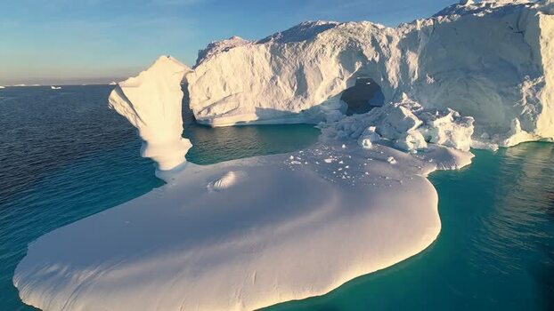 FPV aerial view of arch iceberg in Greenland. FPV aerial view of arch iceberg in Greenland.