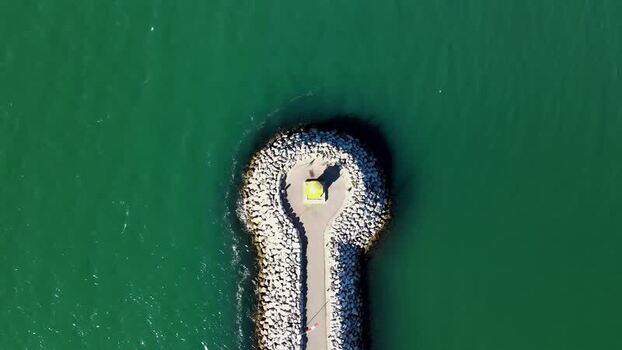 Aerial view of a beacon on a stone pier in Reykjavik Iceland. Aerial view of a beacon on a stone pier in Reykjavik Iceland.