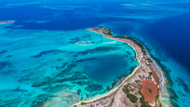 Aerial view of Los Roques archipelago featuring turquoise waters coral reefs and sandy beaches in Los Roques Dependencias Federales Venezuela. Aerial view of Los Roques archipelago featuring turquoise waters coral reefs and sandy beaches in Los Roques Dependencias Federales Venezuela.