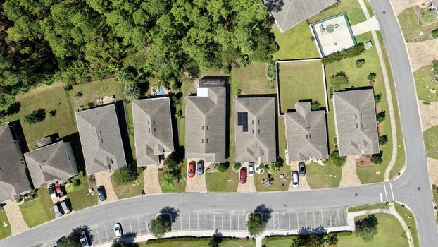 Aerial view of residential houses along Windward Ranch Boulevard with driveways parked cars and green lawns in St. Johns County Florida United States. Aerial view of residential houses along Windward Ranch Boulevard with driveways parked cars and green lawns in St. Johns County Florida United States.