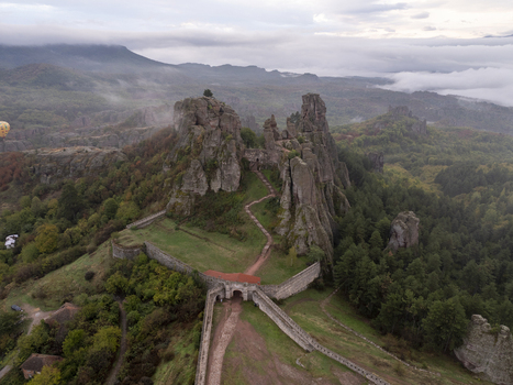 Aerial view of the historic Belogradchik Fortress nestled among dramatic rock formations and lush forests under a cloudy sky in Belogradchik Vidin Bulgaria. Aerial view of the historic Belogradchik Fortress nestled among dramatic rock formations and lush forests under a cloudy sky in Belogradchik Vidin Bulgaria.