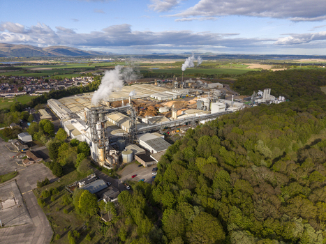 Cowie United Kingdom 06 May 2026 Aerial view of a large industrial timber processing plant with smoking chimneys wood piles and surrounding forest under a cloudy sky. Cowie United Kingdom 06 May 2026 Aerial view of a large industrial timber processing plant with smoking chimneys wood piles and surrounding forest under a cloudy sky.