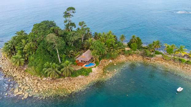 Axim Western Region Ghana 09 February 2023 Aerial view of Lou Moon Resort Eco Luxury nestled on a lush tropical island with palm trees rocky shores and turquoise waters. Axim Western Region Ghana 09 February 2023 Aerial view of Lou Moon Resort Eco Luxury nestled on a lush tropical island with palm trees rocky shores and turquoise waters.