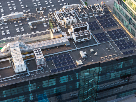 Aerial view of a data center roof featuring numerous HVAC units ventilation systems and rows of solar panels in Gdansk Pomeranian Voivodeship Poland. Aerial view of a data center roof featuring numerous HVAC units ventilation systems and rows of solar panels in Gdansk Pomeranian Voivodeship Poland.