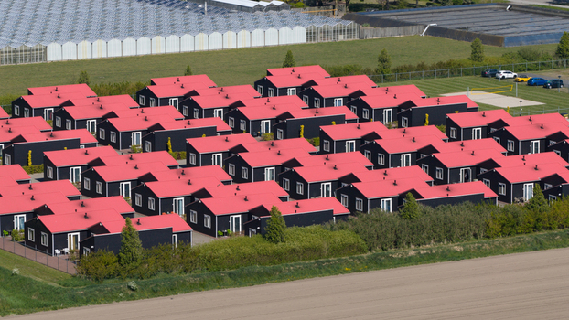 Drone view of AZC Luttelgeest in the Netherlands showing a reception centre for asylum seekers temporary housing community facilities and social infrastructure. Drone view of AZC Luttelgeest in the Netherlands showing a reception centre for asylum seekers temporary housing community facilities and social infrastructure.