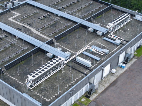 Aerial view of an AI data center cooling system with industrial chillers and piping installed on a flat roof in Krakow Lesser Poland Voivode Poland. Aerial view of an AI data center cooling system with industrial chillers and piping installed on a flat roof in Krakow Lesser Poland Voivode Poland.