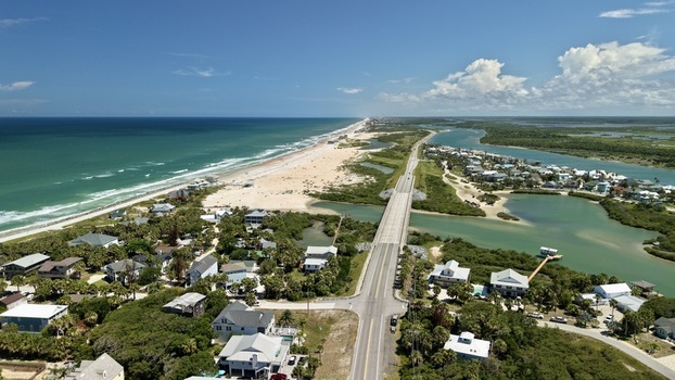 Aerial view of Matanzas Inlet with its bridge connecting coastal residential areas sandy beaches and the Atlantic Ocean in St. Johns County Florida United States. Aerial view of Matanzas Inlet with its bridge connecting coastal residential areas sandy beaches and the Atlantic Ocean in St. Johns County Florida United States.