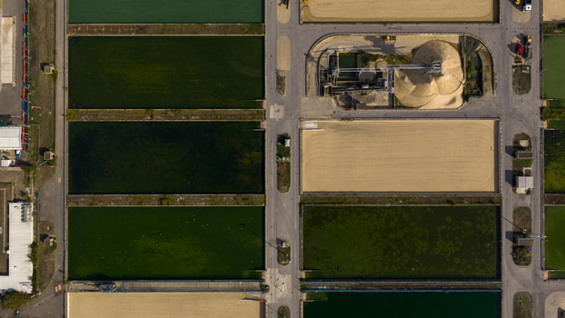 Aerial view of Ashford Common Water Treatment Works featuring rectangular water filtration basins sediment tanks and industrial infrastructure in Shepperton England United Kingdom. Aerial view of Ashford Common Water Treatment Works featuring rectangular water filtration basins sediment tanks and industrial infrastructure in Shepperton England United Kingdom.
