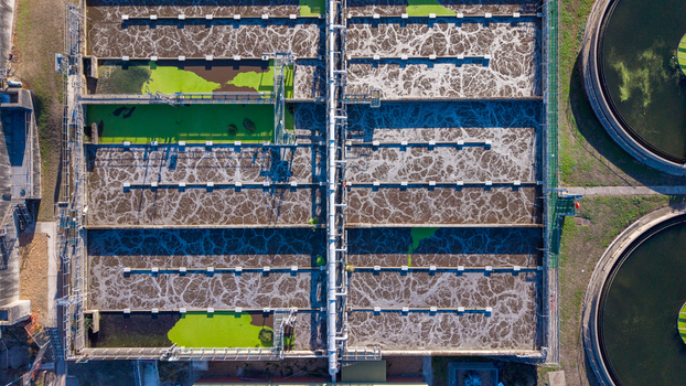 Aerial view of the Water Treatment Centre Camberley featuring large aeration tanks with bubbling water and industrial infrastructure in Camberley England United Kingdom. Aerial view of the Water Treatment Centre Camberley featuring large aeration tanks with bubbling water and industrial infrastructure in Camberley England United Kingdom.