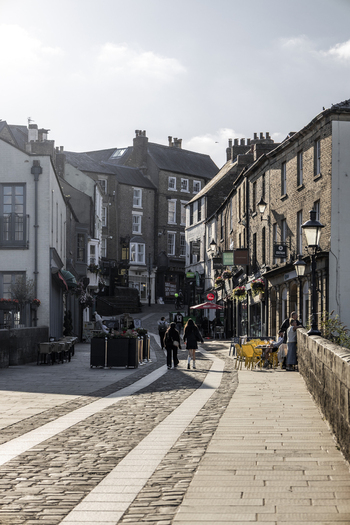 Durham England United Kingdom 13 July 2026 View of historic streets in Durham with pedestrians walking along the stone paved walkway brick buildings and outdoor seating. Durham England United Kingdom 13 July 2026 View of historic streets in Durham with pedestrians walking along the stone paved walkway brick buildings and outdoor seating.