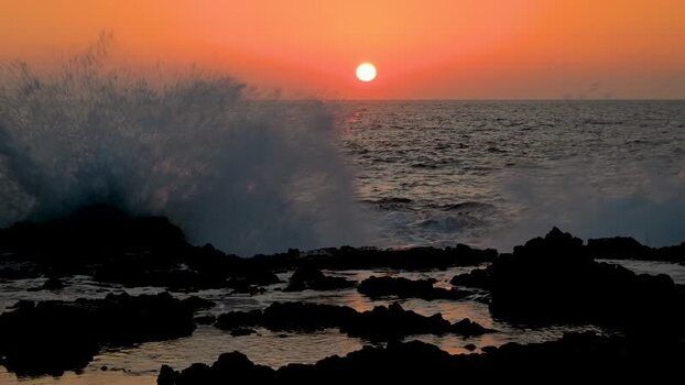 View of sunset over rocky ocean United States.