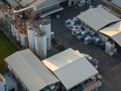 Melbourne VIC Australia 22 September 2026 Aerial view of industrial facilities in Kilsyth featuring large metal storage tanks stacked storage containers and factory buildings. Melbourne VIC Australia 22 September 2026 Aerial view of industrial facilities in Kilsyth featuring large metal storage tanks stacked storage containers and factory buildings.