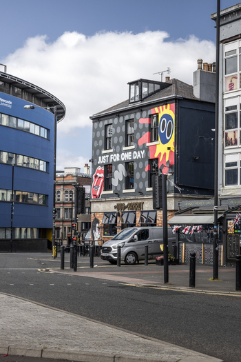 Newcastle upon Tyne United Kingdom 13 July 2026 View of the Dog and Parrot pub featuring a mural with the Rolling Stones tongue logo and text situated on a city street with a parked van. Newcastle upon Tyne United Kingdom 13 July 2026 View of the Dog and Parrot pub featuring a mural with the Rolling Stones tongue logo and text situated on a city street with a parked van.