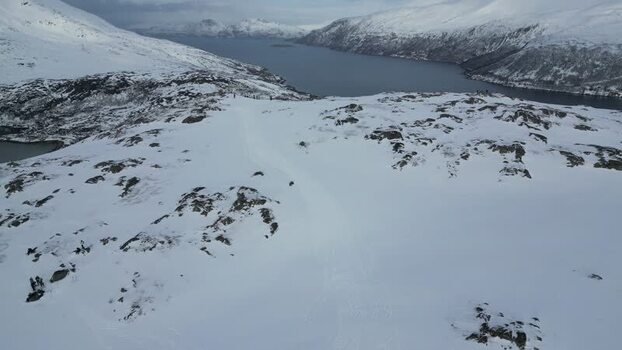 Aerial view of snowy mountains and fjords on Kvaloya Norway.