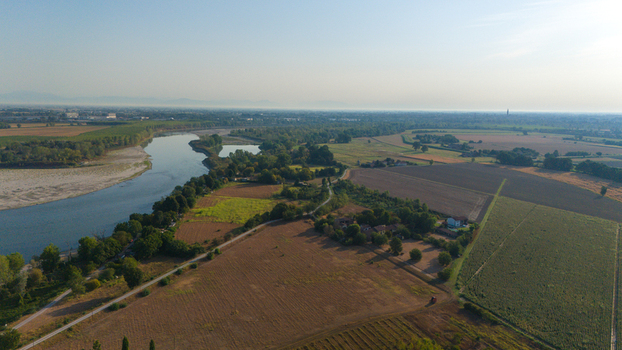 Aerial view of the Po River with low water levels due to drought and summer heatwave exposing riverbed sediments in Castelvetro Piacentino Emilia Romagna Italy. Aerial view of the Po River with low water levels due to drought and summer heatwave exposing riverbed sediments in Castelvetro Piacentino Emilia Romagna Italy.