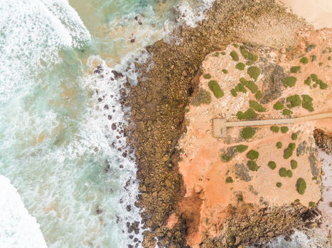 Aerial view of strong waves hitting the shore at Praia da Bordeira Carrapateira Portugal