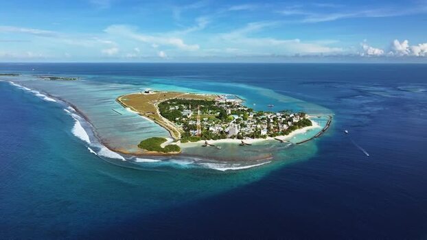 Aerial view of the tropical island and turquoise lagoon Maldives.