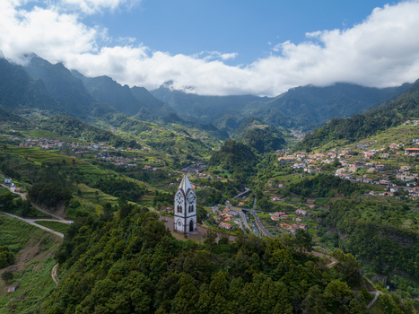 Aerial view of the Chapel of Our Lady of Fatima situated on a verdant hill above the village and terraced slopes of Madeira. Aerial view of the Chapel of Our Lady of Fatima situated on a verdant hill above the village and terraced slopes of Madeira.