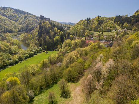 Aerial view of Orava Castle perched on a steep rock above the river and lush green forests under a clear blue sky Dolny Kubin Zilinsky kraj Slovakia. Aerial view of Orava Castle perched on a steep rock above the river and lush green forests under a clear blue sky Dolny Kubin Zilinsky kraj Slovakia.