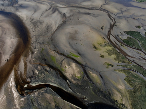Aerial view of Findhorn Bay showing intricate tidal patterns sandbanks and winding water channels at low tide Findhorn Scotland United Kingdom. Aerial view of Findhorn Bay showing intricate tidal patterns sandbanks and winding water channels at low tide Findhorn Scotland United Kingdom.