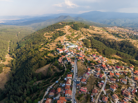 Aerial view of the village with red roofed houses nestled among rolling hills and dense forests in the Pazardzhik region Sveta Petka Pazardzhik Bulgaria. Aerial view of the village with red roofed houses nestled among rolling hills and dense forests in the Pazardzhik region Sveta Petka Pazardzhik Bulgaria.