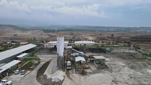 Aerial view of the Dhoho International Airport construction site featuring a concrete batching plant heavy machinery and earthworks in Kecamatan Grogol Jawa Timur Indonesia. Aerial view of the Dhoho International Airport construction site featuring a concrete batching plant heavy machinery and earthworks in Kecamatan Grogol Jawa Timur Indonesia.