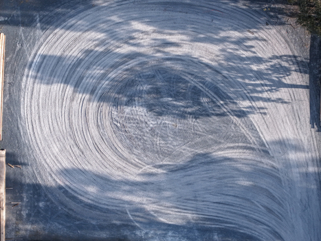 Aerial view of circular tire tracks on an asphalt surface in an industrial area in Melbourne VIC Australia. Aerial view of circular tire tracks on an asphalt surface in an industrial area in Melbourne VIC Australia.