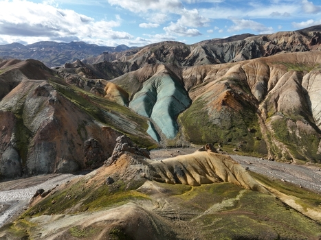Aerial view of Landmannalaugar featuring colorful rhyolite mountains volcanic landscape mossy green patches and rocky terrain in Hella Rangarthing ytra Iceland. Aerial view of Landmannalaugar featuring colorful rhyolite mountains volcanic landscape mossy green patches and rocky terrain in Hella Rangarthing ytra Iceland.