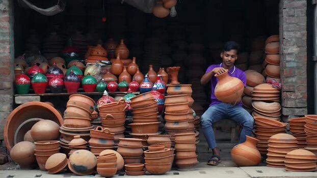 View of a man in a pottery shop Bangladesh. View of a man in a pottery shop Bangladesh.