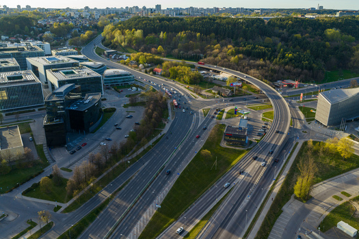 Vilnius County Lithuania 01 May 2026 Aerial view of modern office buildings and a busy highway intersection surrounded by lush green forests. Vilnius County Lithuania 01 May 2026 Aerial view of modern office buildings and a busy highway intersection surrounded by lush green forests.