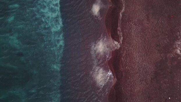 Aerial view of Red beach with turquoise water in Fira Greece.