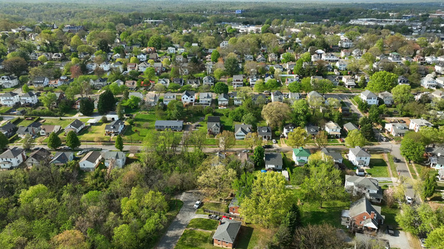 Aerial view of a residential neighborhood with detached houses lush green trees and suburban streets in Lynchburg Virginia United States.