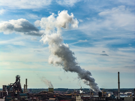 Aerial view of the Tata Steel industrial plant with smoke rising from tall chimneys over the facility in Velsen Noord Noord Holland Netherlands. Aerial view of the Tata Steel industrial plant with smoke rising from tall chimneys over the facility in Velsen Noord Noord Holland Netherlands.
