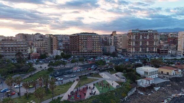 Aerial view of urban buildings and park at sunset in Catania Italy. Aerial view of urban buildings and park at sunset in Catania Italy.