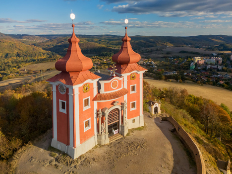 Aerial view of the Stiavnica Calvary a historic religious complex with red roofed towers situated on a hill overlooking Banska Stiavnica Banskobystricky kraj Slovakia. Aerial view of the Stiavnica Calvary a historic religious complex with red roofed towers situated on a hill overlooking Banska Stiavnica Banskobystricky kraj Slovakia.