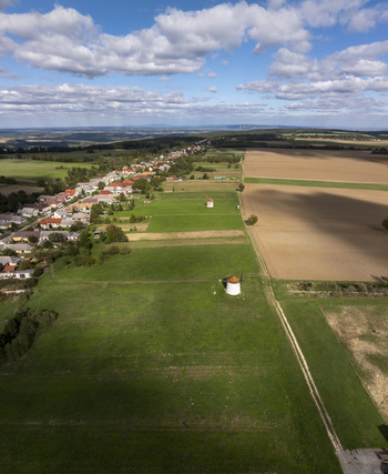 Aerial view of the historic Tesi Windmills and Smithy surrounded by green fields rural landscape and the village of Tes Hungary. Aerial view of the historic Tesi Windmills and Smithy surrounded by green fields rural landscape and the village of Tes Hungary.