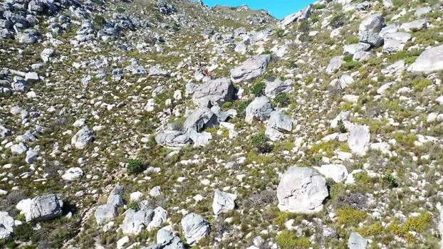 Aerial view of hikers on a rocky mountain trail South Africa.