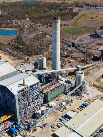 Aerial view of Millmerran Power Station with its tall chimney industrial infrastructure conveyor belts and surrounding rural landscape in Domville Queensland Australia. Aerial view of Millmerran Power Station with its tall chimney industrial infrastructure conveyor belts and surrounding rural landscape in Domville Queensland Australia.