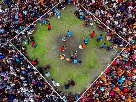 Nilphamari Bangladesh 01 May 2026 Aerial view of a large crowd of people gathered around a square grassy field for a traditional performance or sporting event. Nilphamari Bangladesh 01 May 2026 Aerial view of a large crowd of people gathered around a square grassy field for a traditional performance or sporting event.
