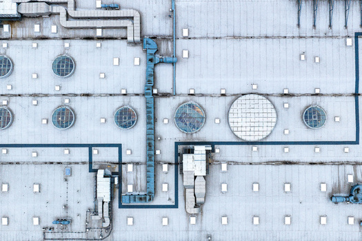 Aerial view of the roof of CH Targowek shopping center featuring circular skylights ventilation ducts and HVAC systems in Warsaw Masovian Voivodeship Poland. Aerial view of the roof of CH Targowek shopping center featuring circular skylights ventilation ducts and HVAC systems in Warsaw Masovian Voivodeship Poland.
