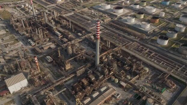 Aerial view of the industrial refinery complex and chimneys Italy. Aerial view of the industrial refinery complex and chimneys Italy.