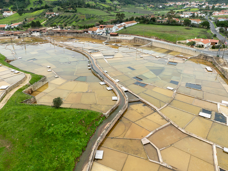 Aerial view of the historic Salinas de Rio Maior salt pans featuring rectangular evaporation ponds and wooden structures in the countryside Rio Maior Santarem Portugal. Aerial view of the historic Salinas de Rio Maior salt pans featuring rectangular evaporation ponds and wooden structures in the countryside Rio Maior Santarem Portugal.