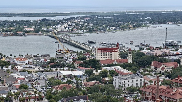 Aerial view of the Bridge of Lions spanning the Matanzas River with historic buildings boats and a construction crane in St. Augustine Florida United States. Aerial view of the Bridge of Lions spanning the Matanzas River with historic buildings boats and a construction crane in St. Augustine Florida United States.