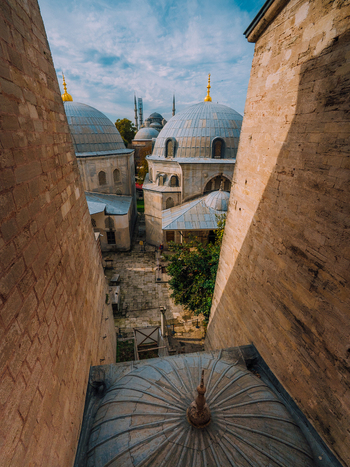 Istanbul Turkiye 07 October 2019 View of the majestic domes of the Hagia Sophia complex pierce the skyline a symphony of grey stone against a backdrop of a bright blue sky.