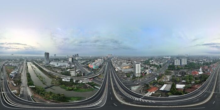 Aerial view of a highway interchange and urban landscape with buildings and a river in Bekasi Barat West Java Indonesia. Aerial view of a highway interchange and urban landscape with buildings and a river in Bekasi Barat West Java Indonesia.